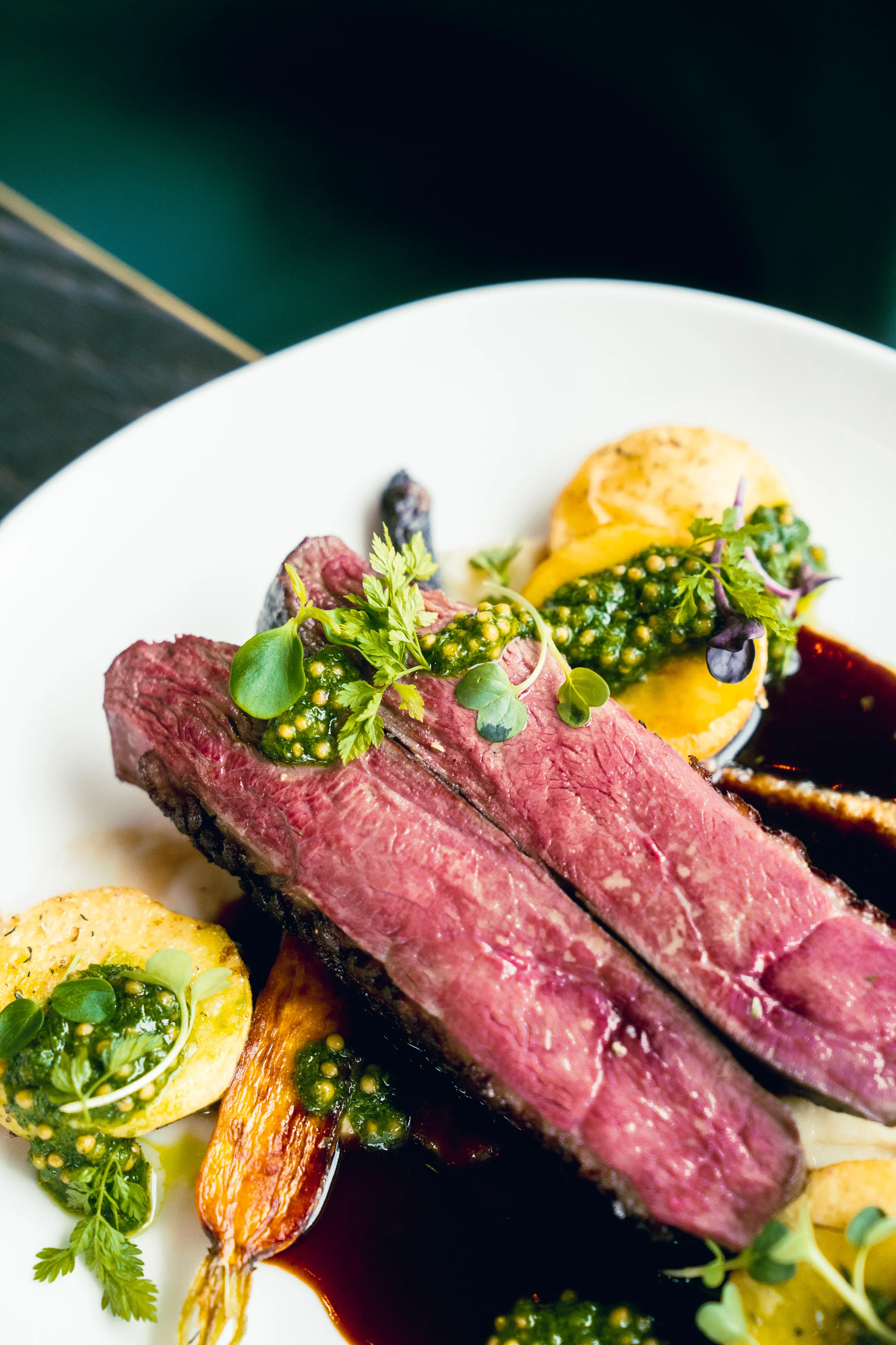 Seared beef with heirloom carrots, herb oil and jus