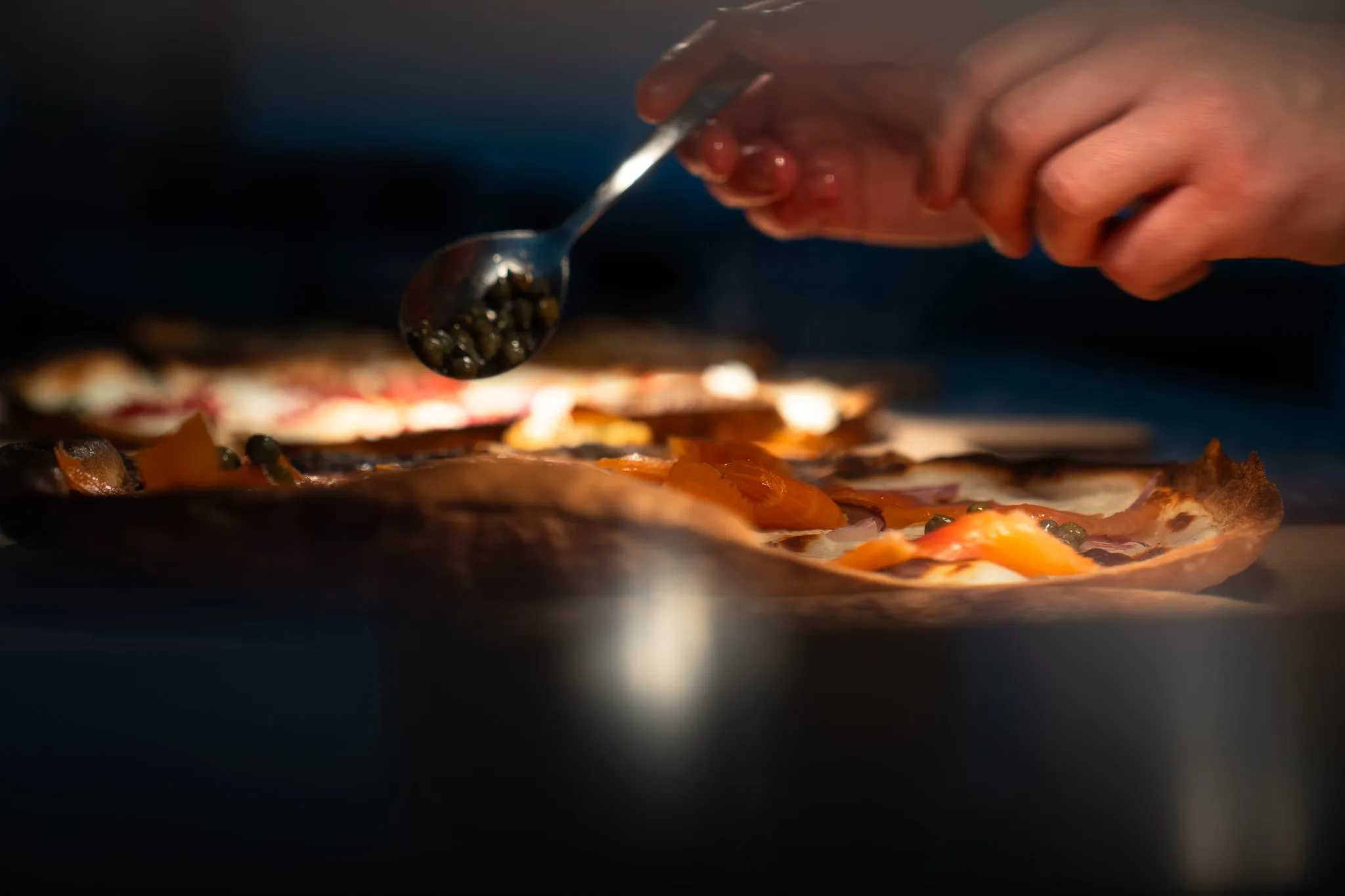 Chef garnishing a dish tableside