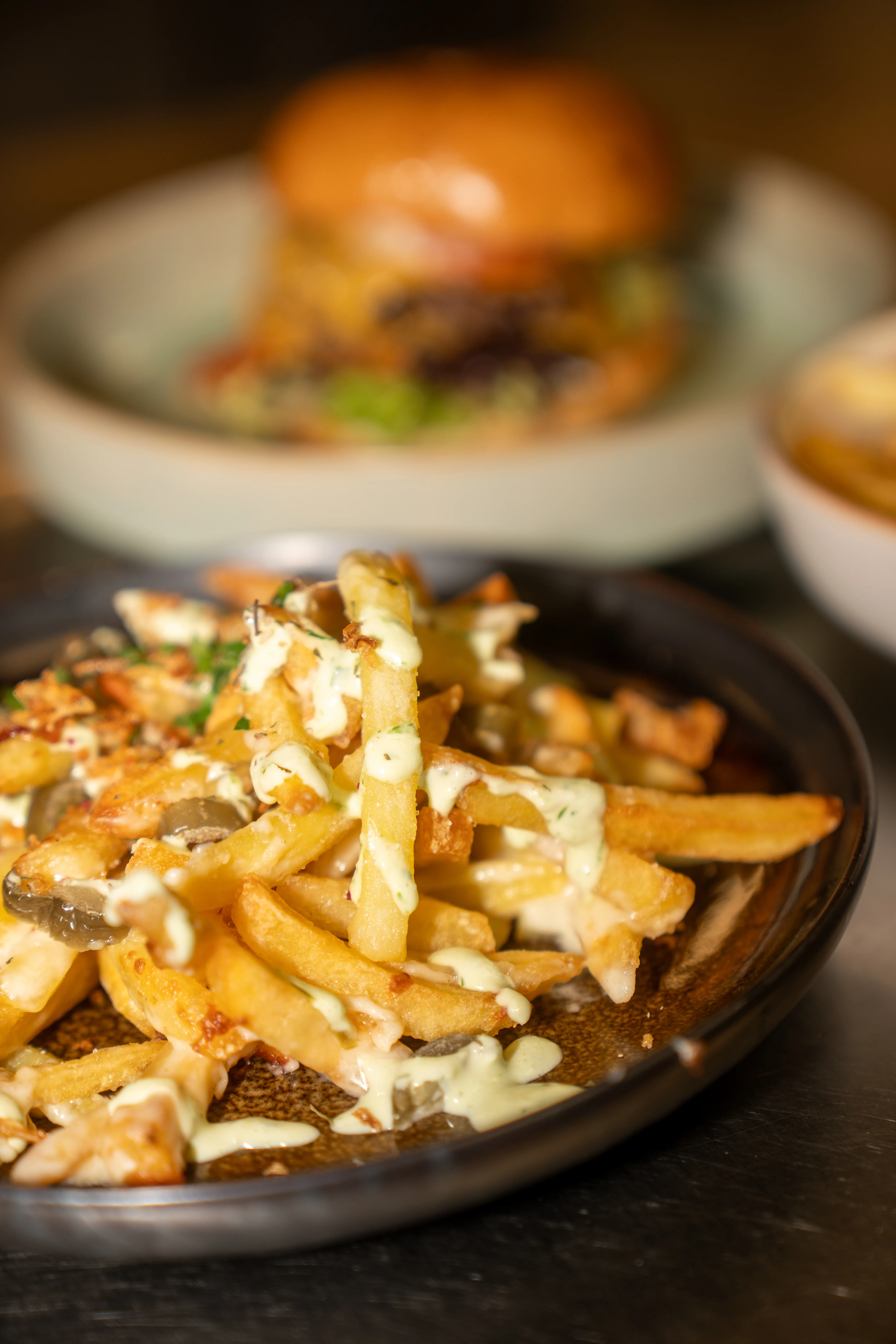 Fries topped with cheese and herbs