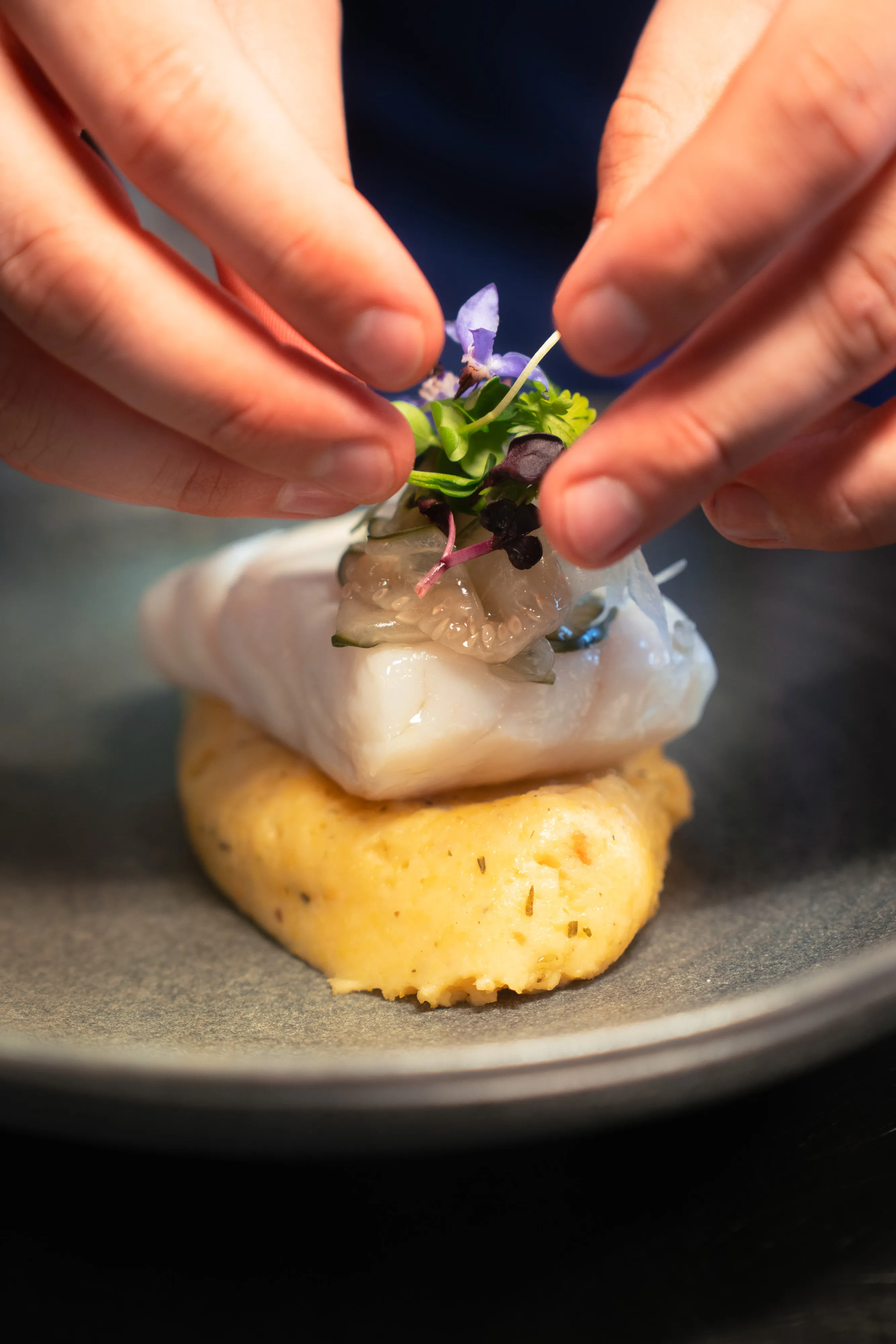 Plating a fish dish with edible flowers