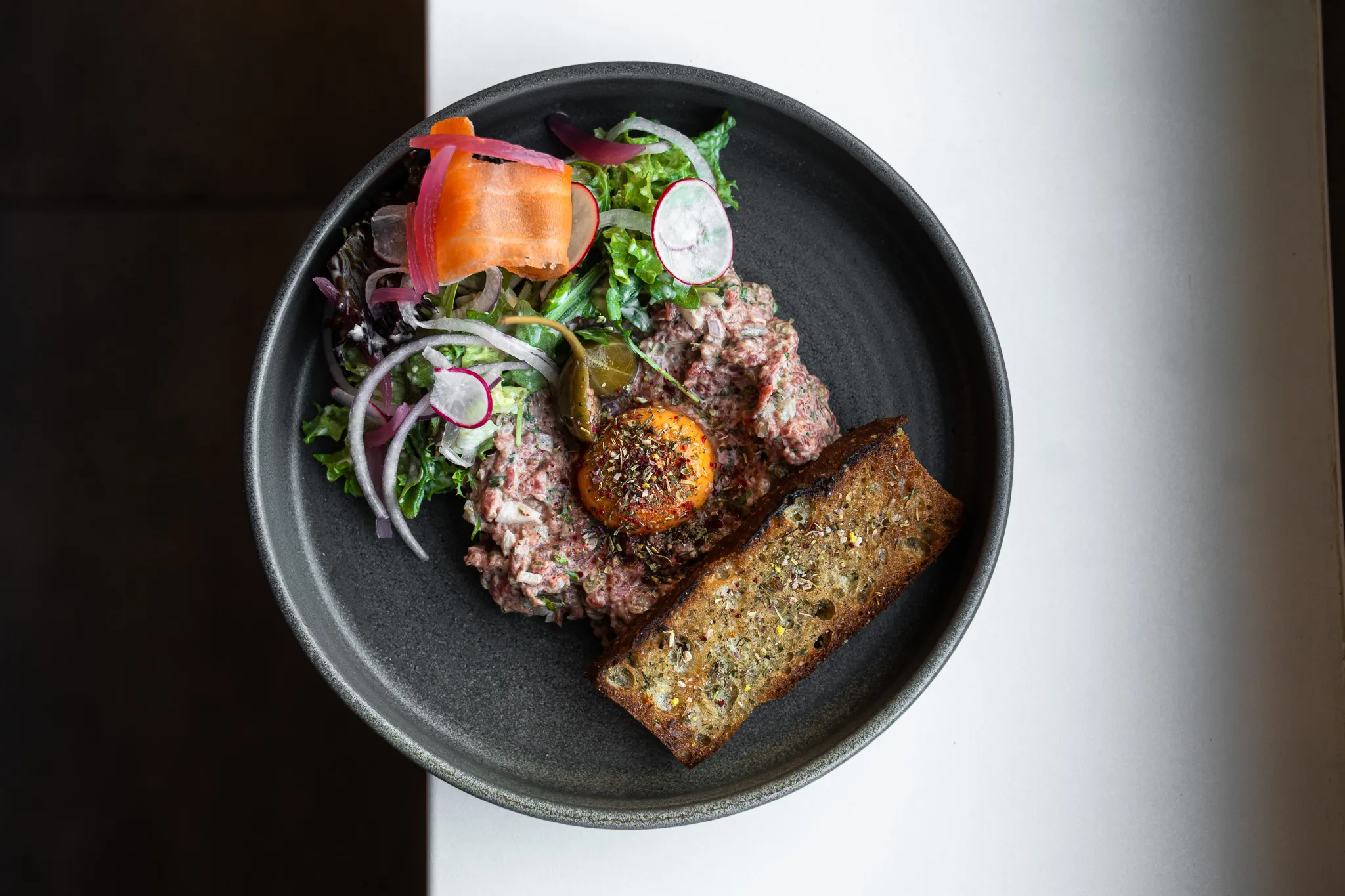 Beef tartare with egg yolk, overhead view