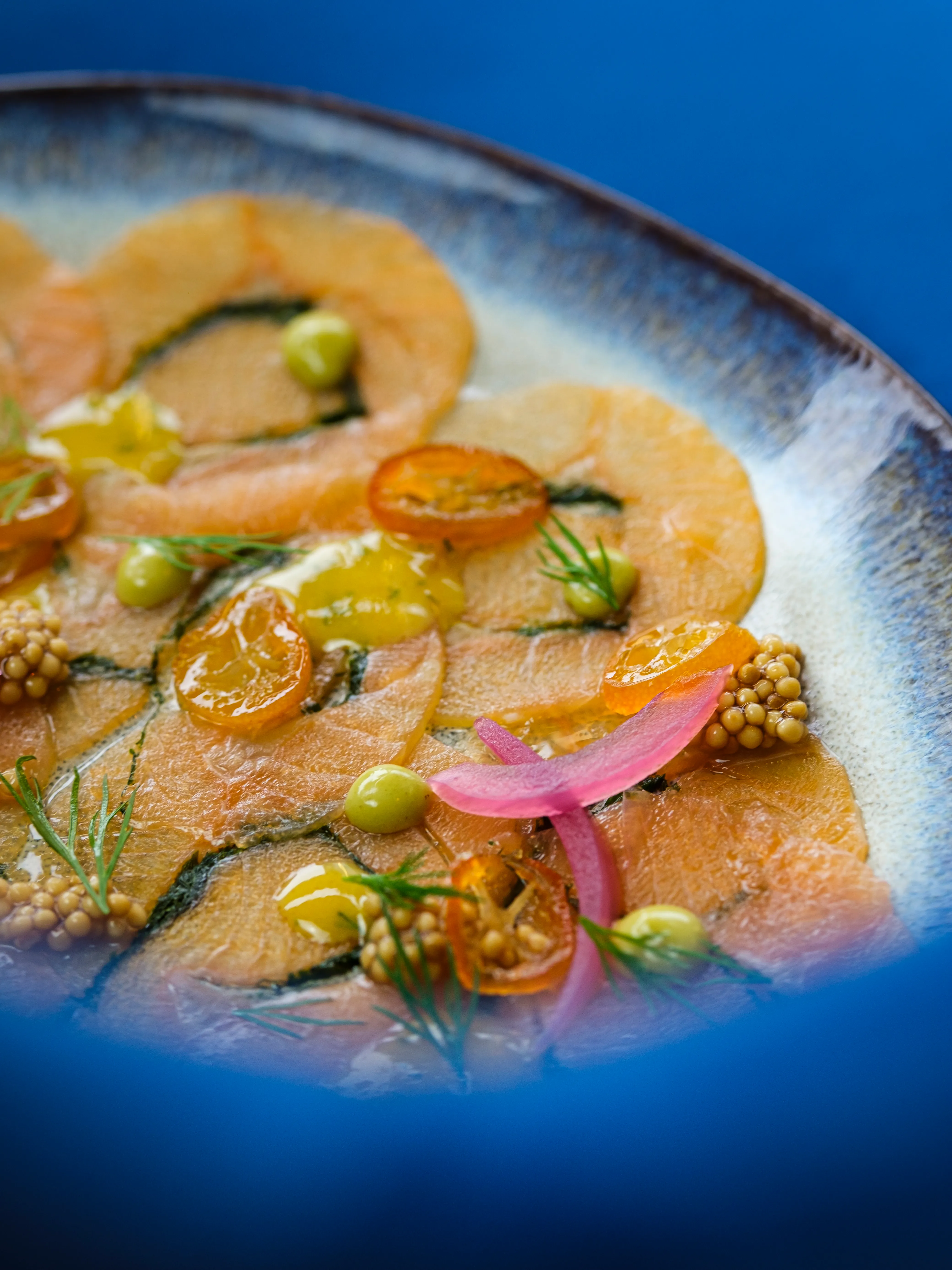 Salmon carpaccio with citrus and pickled onion
