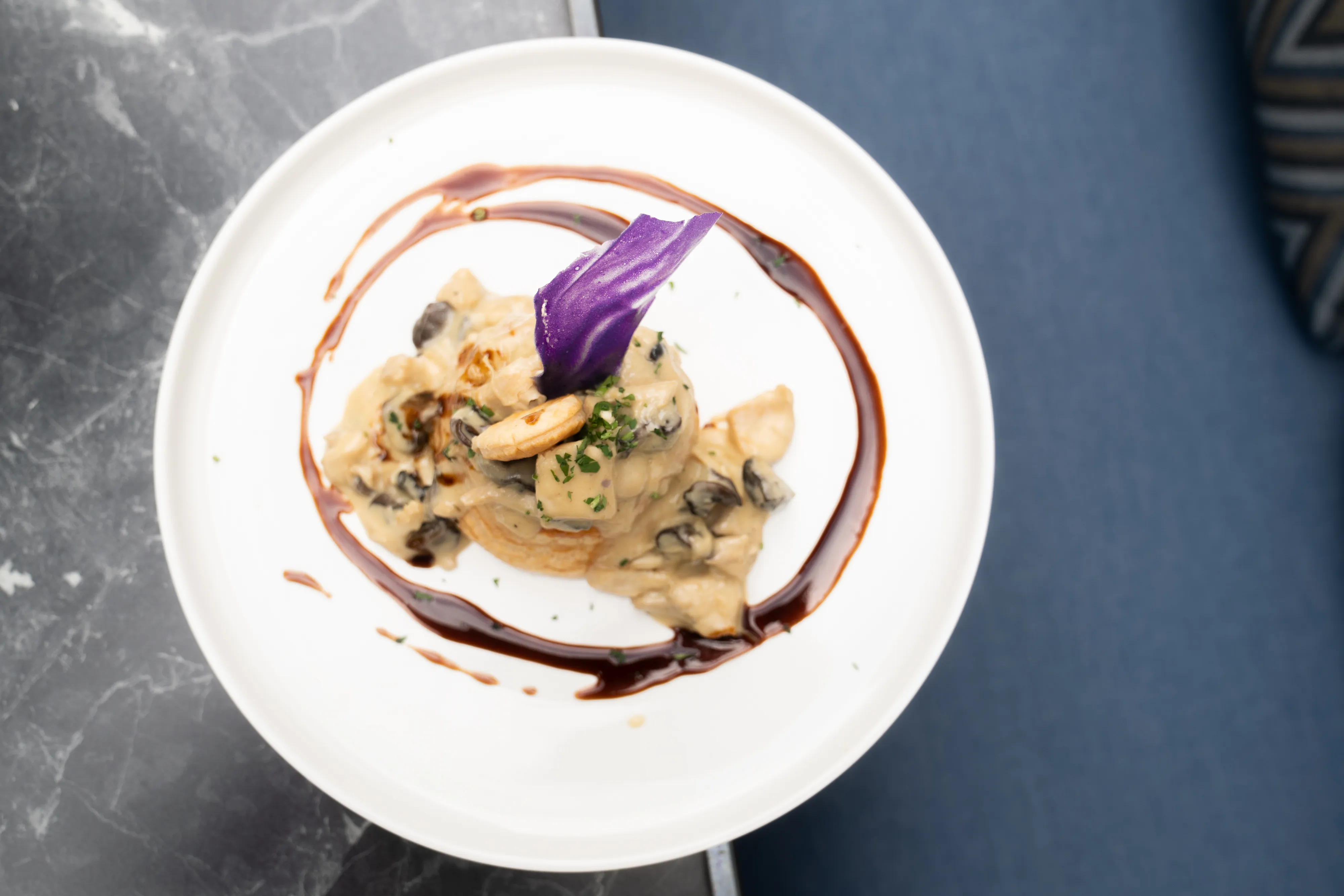 Vol-au-vent with wild mushrooms, overhead on marble